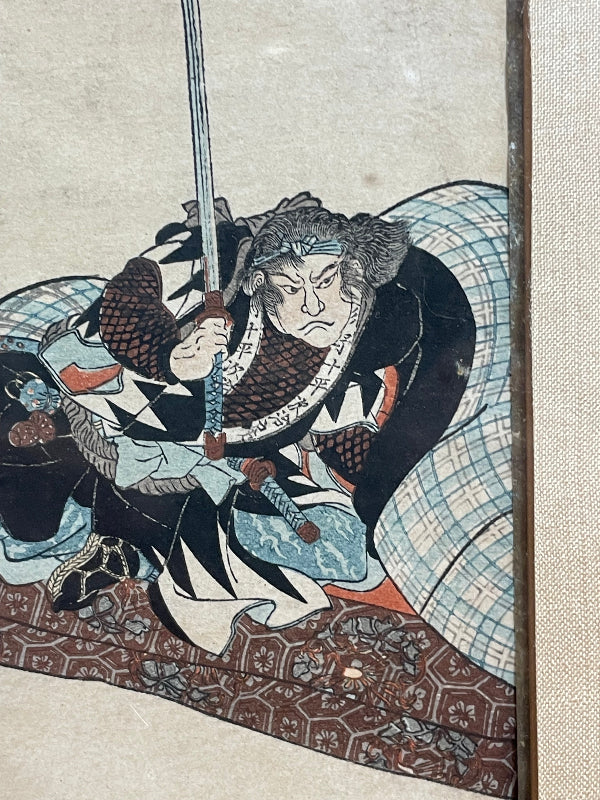 Traditional Japanese artwork of a warrior holding a sword with intricate patterns.