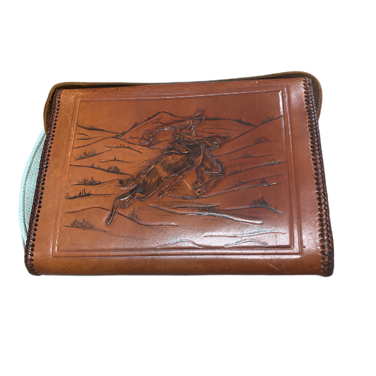 Brown leather wallet with embossed design of a horse and rider on a white background