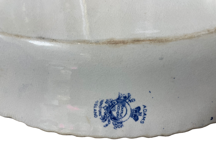 Close-up of a ceramic dish with a blue logo