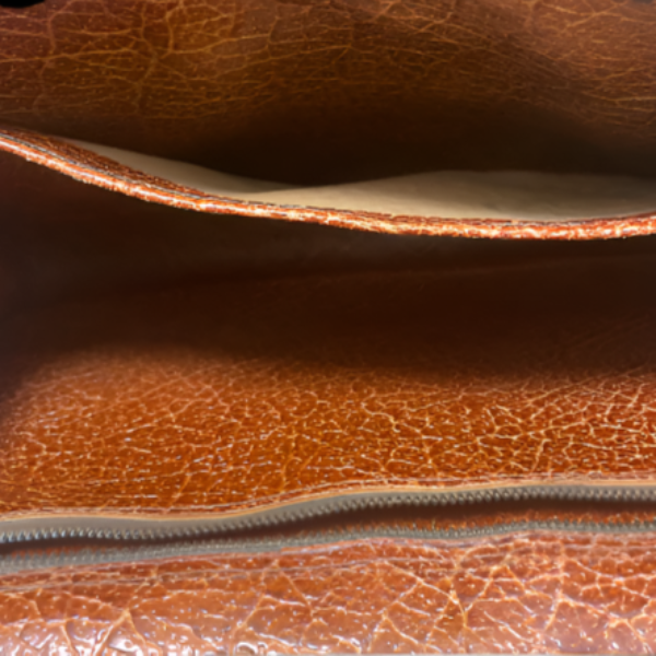 Close-up of a brown leather clutch bag