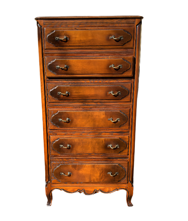 Wooden dresser with decorative carvings on a wooden deck