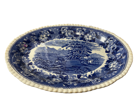 Blue and white decorative plate with a scenic design
