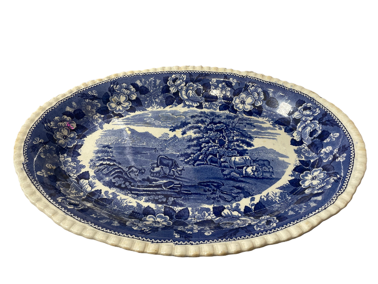 Blue and white decorative plate with a scenic design