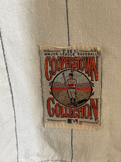 Label with 'Major League Baseball' text on a textured fabric background