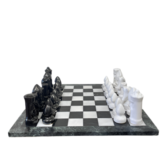 Black and white chess pieces on a checkered board with marble-like surface.