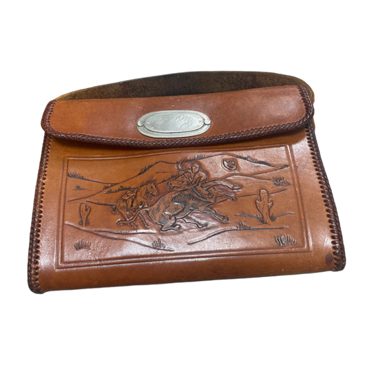 Brown leather pouch with embossed design and metal clasp on a white background
