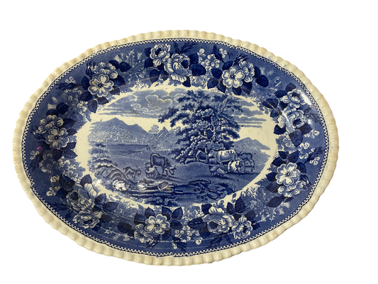 Decorative blue and white plate with a landscape design